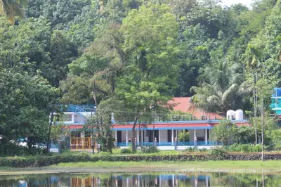 a house on the shore of a lake at Jewel Homes Thattekad For birding and families - An ISO9001 ISO14001 ISO22000 Certified in Thattakād