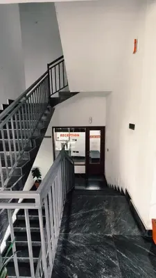 a stairway in a building with a stair case at Nelleri Residency Managed By Vaishno Hospitality in Iritti