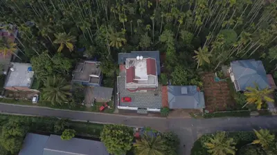 an overhead view of a city with houses and trees at Wayanadan Huts Homestay in Sultan Bathery