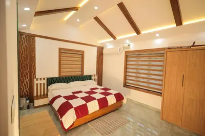 a bedroom with a bed and a large window at Wayanadan Huts Homestay in Sultan Bathery