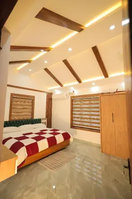 a bedroom with a bed in a room at Wayanadan Huts Homestay in Sultan Bathery