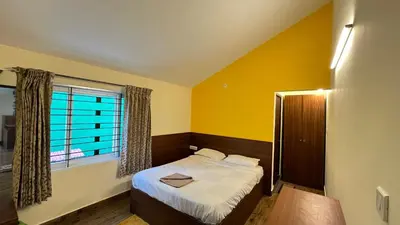 a small bedroom with a bed and a window at Away From Home - 7 - Home Stay Ooty, Entire 3BHK Villa in Ooty