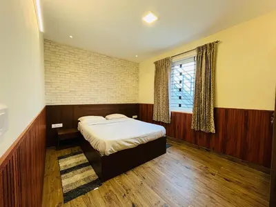 a bedroom with a bed and a window at Away From Home - 7 - Home Stay Ooty, Entire 3BHK Villa in Ooty