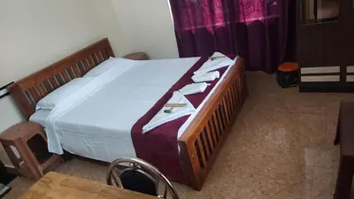 a bedroom with a bed with towels on it at Blue Hills View in Attappādi