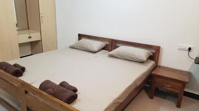 a bedroom with a wooden bed with two pillows at Cliff view in Ooty