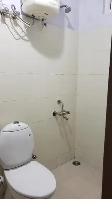 a bathroom with a toilet and a shower at Cliff view in Ooty