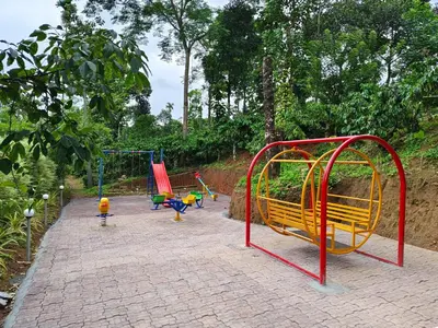a playground with colorful play equipment in a park at Himadri Retreat Wayanad in Kaniyāmbetta