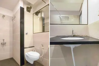 a bathroom with a sink and a toilet at Townhouse Oak Mysuru Railway Museum in Mysore