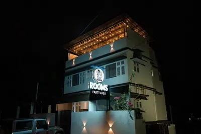 a building with a clock on the side of it at Beach House in Kozhikode