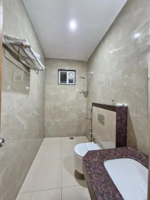 a bathroom with a toilet and a sink at Le Royal Suite in Udumalaippettai