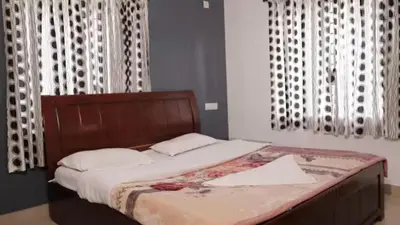 a bed with a wooden headboard in a bedroom at Maria villa in Ooty