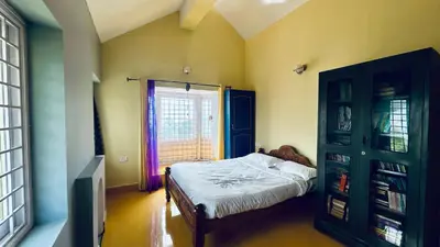 a bedroom with a bed and a window at Away From Home - 1 - Home Stay Ooty, Entire 3BHK Villa in Ooty