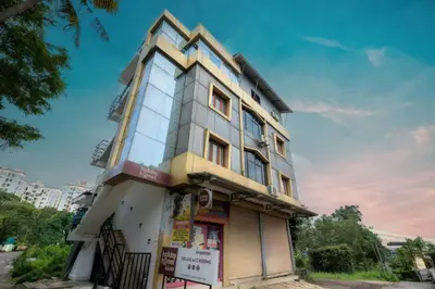a building on the corner of a street at Holiday Homes Aluva in Alwaye