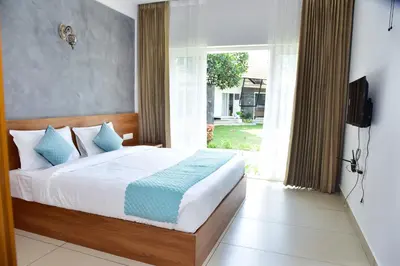 a bedroom with a bed and a television in it at Snow White Wayanad in Wayanad