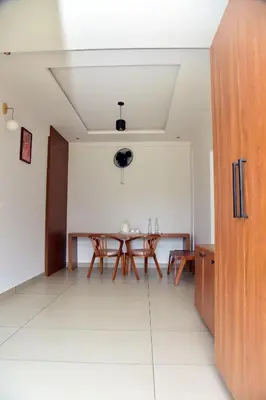 a dining room with a table in a room at Snow White Wayanad in Wayanad