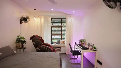 a bedroom with a bed and a desk with a chair at Ekta Pool Farmstay Pollachi in Pollāchi