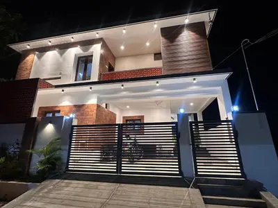 a house with a gate in front of it at night at Kanchana Sirur home in Coimbatore