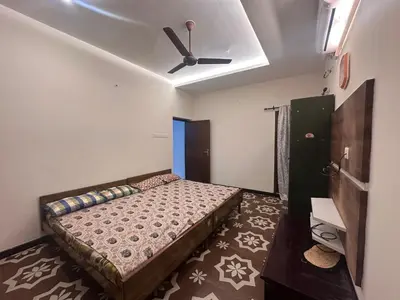 a bedroom with a bed and a ceiling fan at Kanchana Sirur home in Coimbatore