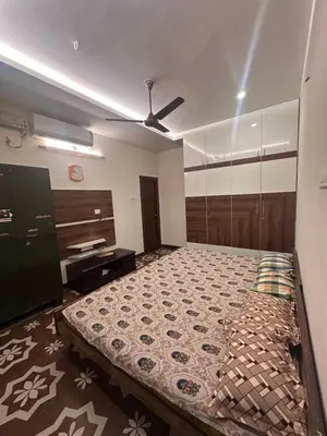 a bedroom with a bed and a ceiling fan at Kanchana Sirur home in Coimbatore