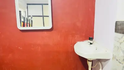 a bathroom with a sink and a mirror at Mysuru dorm-sgh in Mysore