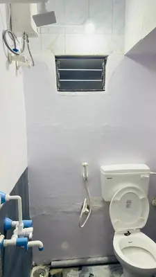 a bathroom with a toilet and a shower at Mysuru dorm-sgh in Mysore