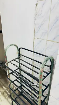 a metal bench chained to a wall at Mysuru dorm-sgh in Mysore