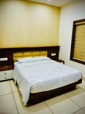 a bedroom with a large bed in a room at Executive Room in Kelakam
