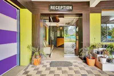 an entrance to a restaurant with potted plants at Hotel O Coorg Hanging Bridge in Kushālnagar