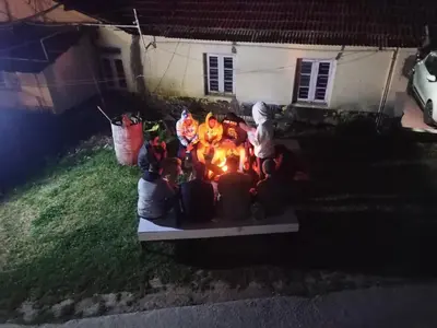 a group of stuffed animals sitting around a fire at Bykerstops in Ooty