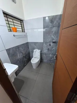 a bathroom with a toilet and a sink at Zainab Apartment in Perintalmanna