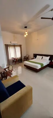 a large bedroom with a bed and a couch at SAF RESIDENCY mukkam in Mukkam