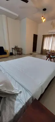 a large white bed in a large room at SAF RESIDENCY mukkam in Mukkam