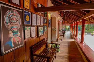 a hallway with benches and pictures on the wall at Kudajadri Drizzle Homestay in Kaniyāmbetta