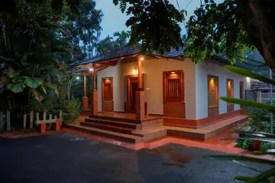 a small house with a pathway leading to it at Kudajadri Drizzle Homestay in Kaniyāmbetta