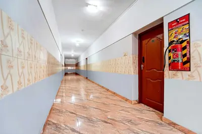 a long hallway with a door and a tile floor at Collection O Central Railway Station Tiruppur in Tiruppūr