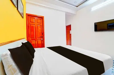 a bedroom with a bed and a red door at Collection O Ooty Government Rose Garden in Ooty