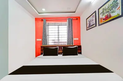 a bedroom with a bed and a window at Collection O Ooty Government Rose Garden in Ooty