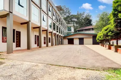 an empty parking lot in front of a building at Collection O Waynad Near Sulthan Bathery in Wayanad