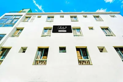 a white building with a black sign on it at Collection O Teresian College Mysore in Mysore