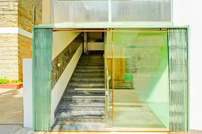 a staircase leading up to a building with a glass door at Collection O Teresian College Mysore in Mysore