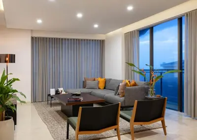 a living room with a couch and a table at Quad One in Kozhikode