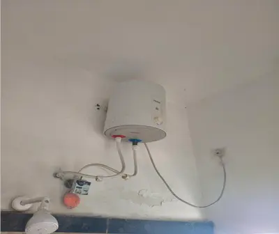 a light on the wall of a bathroom at Prm classic lodge in Erode