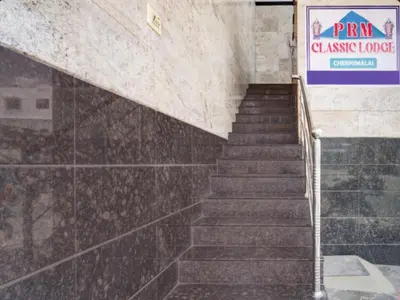 a staircase in a building with a sign on the wall at Prm classic lodge in Erode