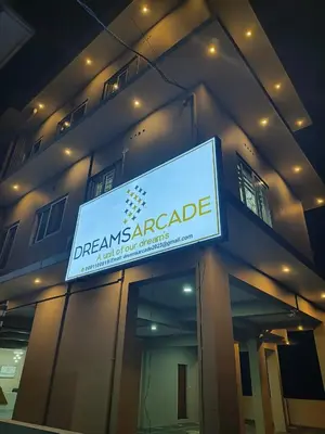 a sign on the side of a building at Dreams Arcade in Nedumbassery