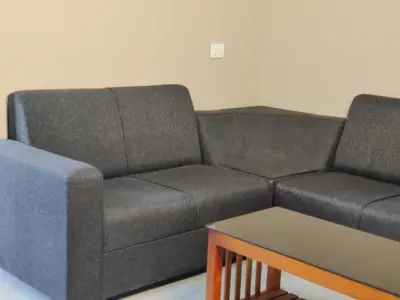 a couch and a table in a living room at Dreams Arcade in Nedumbassery