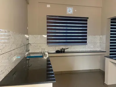 a bathroom with a sink and a shower and a window at Dreams Arcade in Nedumbassery