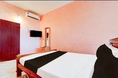 a bedroom with a bed and a flat screen tv at IQ Rooms in Kozhikode