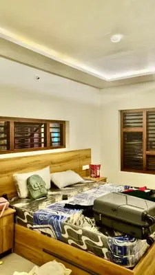 a bedroom with a bed with a suitcase on it at Little Home in Sultan Bathery