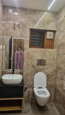 a bathroom with a white toilet and a sink at Little Home in Sultan Bathery