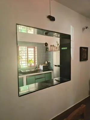 a large mirror on the wall of a kitchen at Reevilla in Madikeri